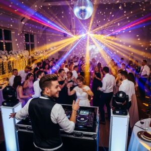 A lively wedding reception with guests dancing under colorful lights and a DJ guiding the party